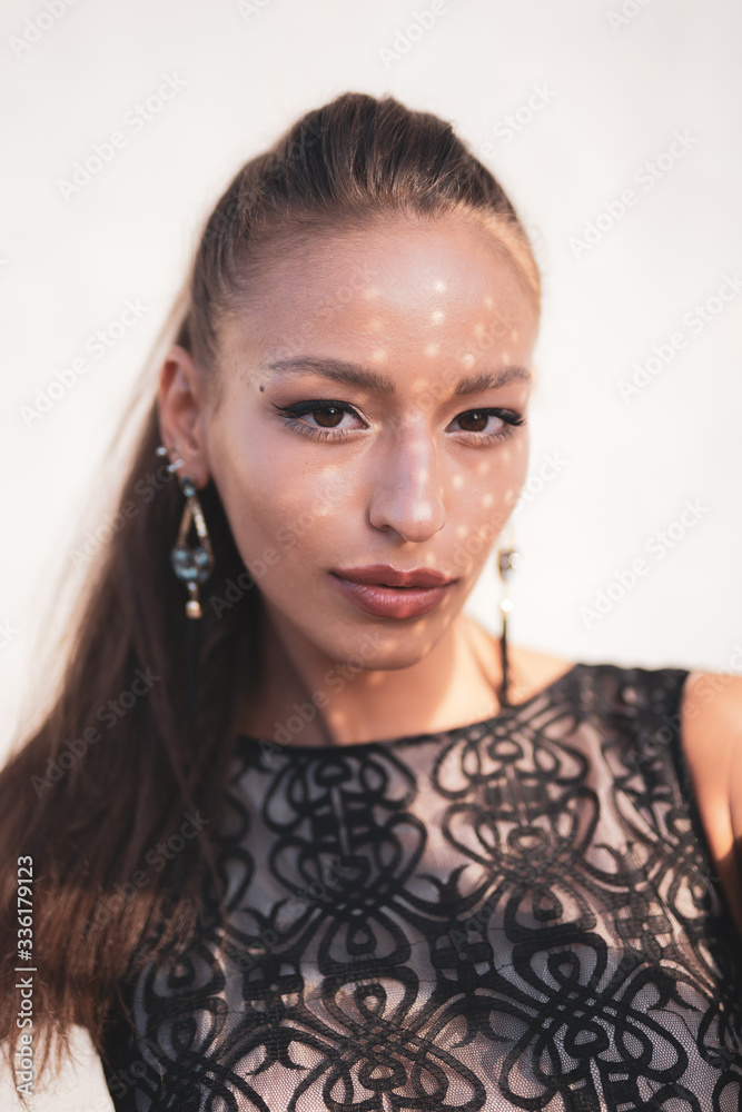 face of beautiful sophisticated girl with shadow play on the face. girl with beautiful lips.