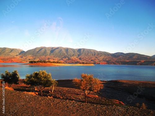 -  Landscape of a large lake with the mountain range appearing in the background. It's extraordinary.