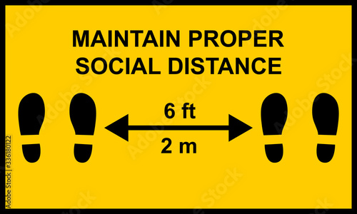 Warning sign reminding people to keep a minimum distance of six feet or two meters between them.  Social distance public health measures to prevent further spread of Covid-19 infections.