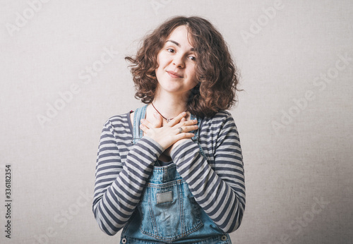 Joyful woman holding hands on his chest