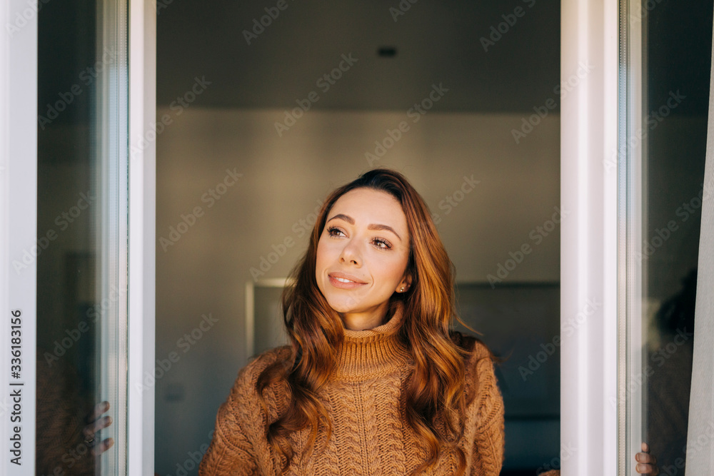 Portrait of young woman at the window Portrait of young woman at the window