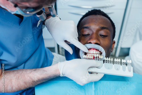Patient getting dental teeth whitening treatment photo