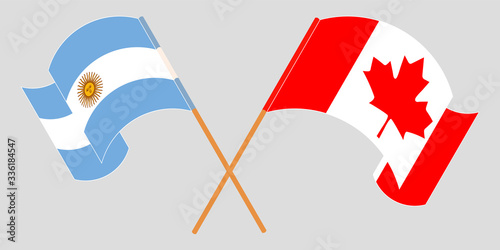 Crossed and waving flags of Argentina and Canada