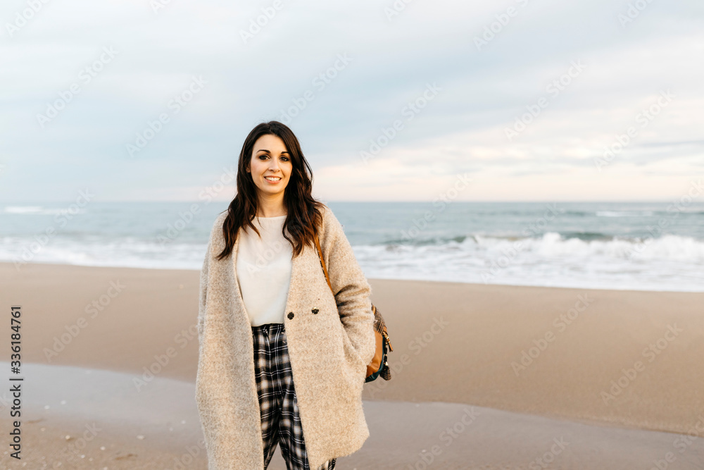 Portrait of a young woman on a remote beach at sunset Portrait of a young woman on a remote beach at sunset