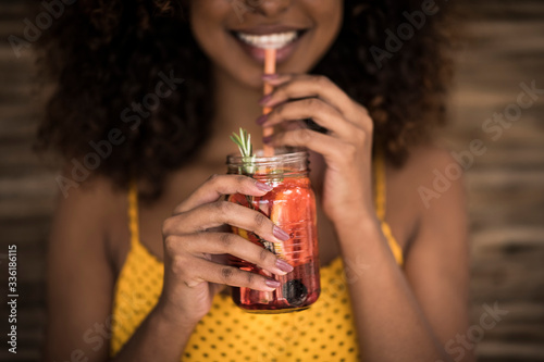 Close-up of woman drinking fresh ice tea drink