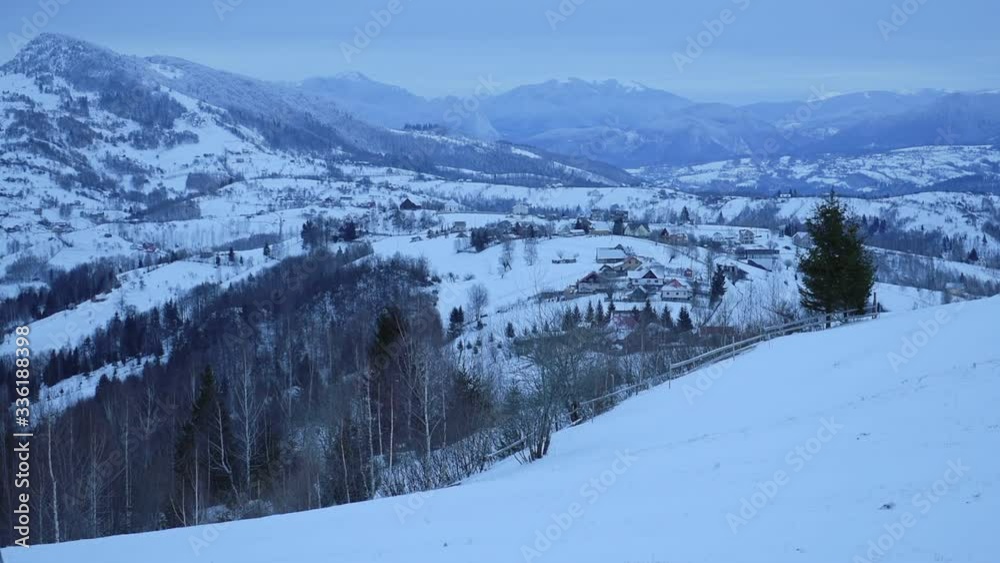 Snowy mountains landscape view, near Bran town, Romania, on a cold and cloudy evening Snowy mountains landscape view, near Bran town, Romania, on a cold and cloudy evening
