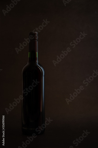 Red wine bottle on rocky background