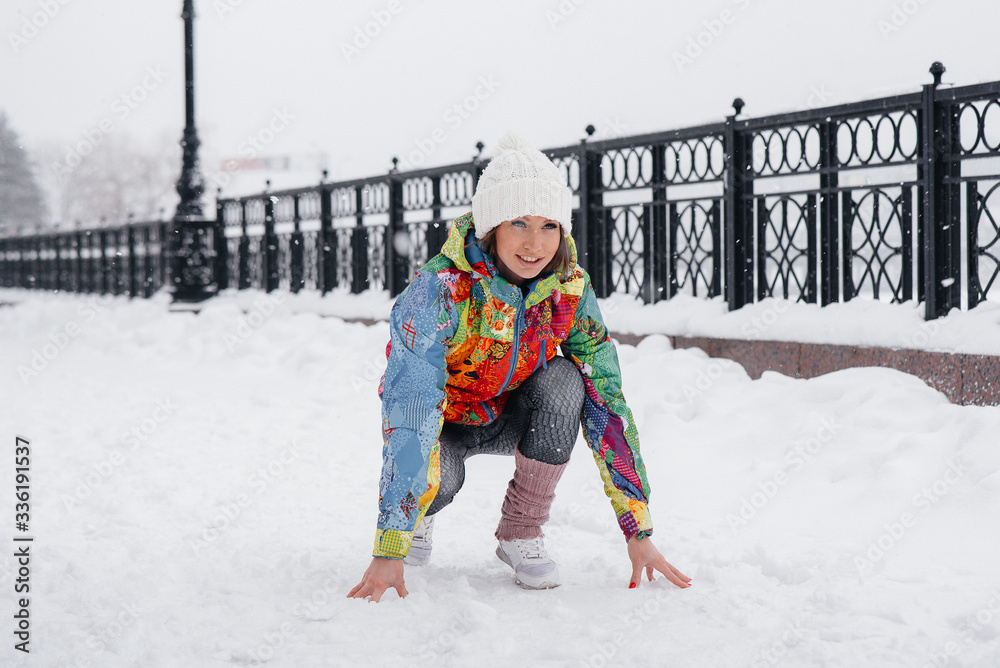 A beautiful young girl is Jogging on a frosty and snowy day. Sports, healthy lifestyle