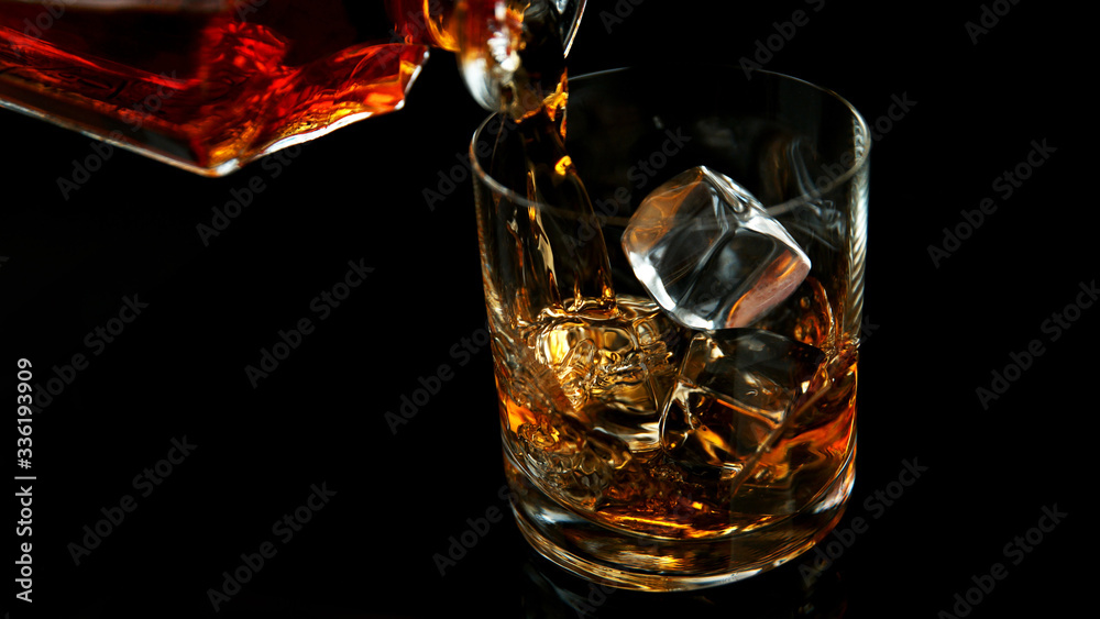 Detail of pouring whiskey into glass