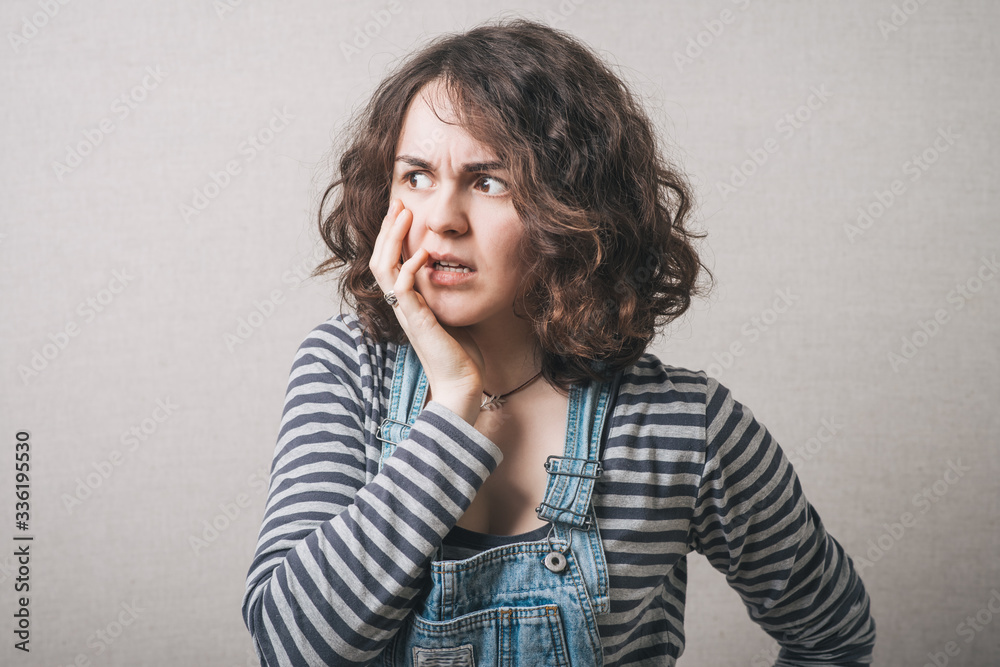 Woman surprised by bad news. Gray background Woman surprised by bad news. Gray background