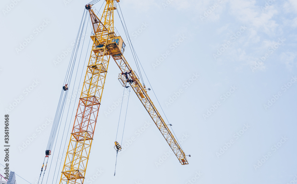 Close up of construction crane on background of blue sky.