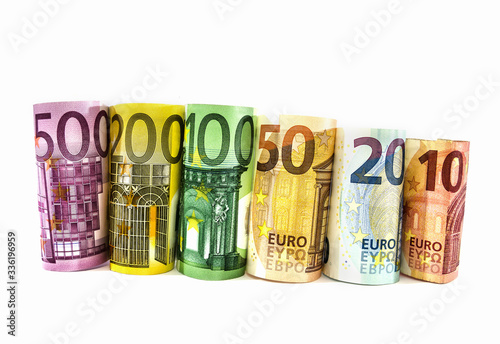 different euros twisted into a roll on a white background. Business concept.