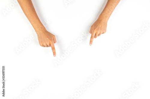 Kid hands pointing down with fingers to something on white background photo