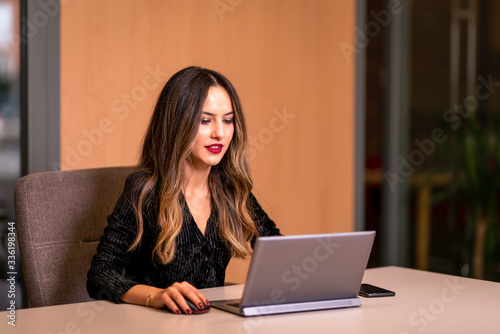 A woman who works on a computer at work