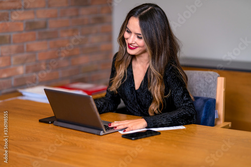 A woman who works on a computer at work