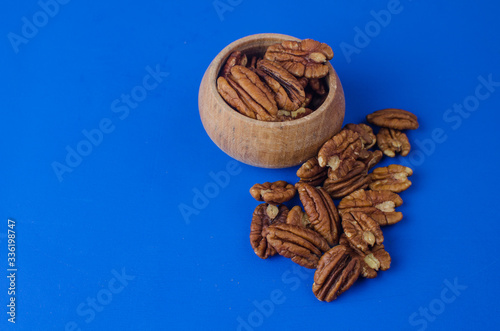 Pekan nut close-up on a classic blue background. photo