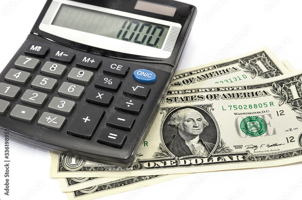 dollars and calculator on white dollars and calculator on white