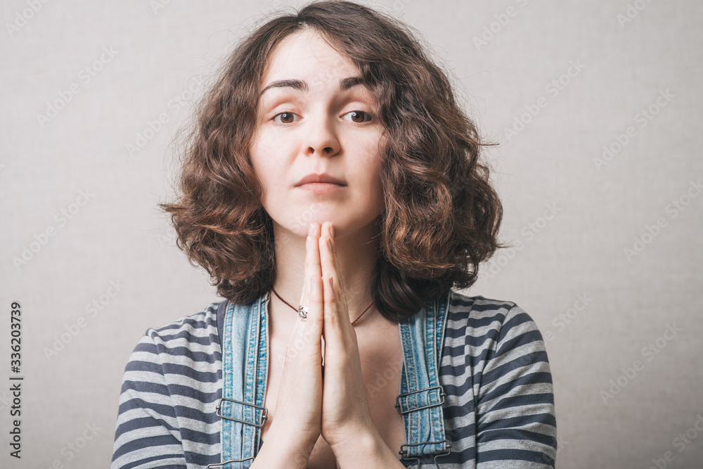 Closeup portrait of a young woman praying Closeup portrait of a young woman praying
