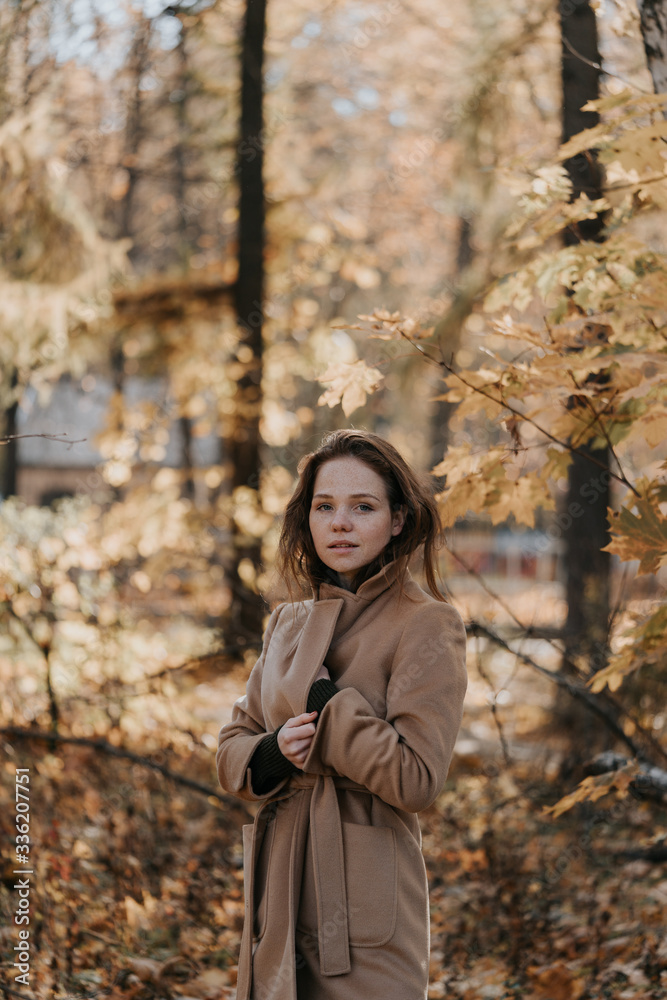 Portrait of a red-haired young girl in autumn outdoors Portrait of a red-haired young girl in autumn outdoors
