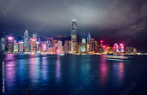 View of Victoria Harbor and Hong Kong at night. Urban landscape. © badahos