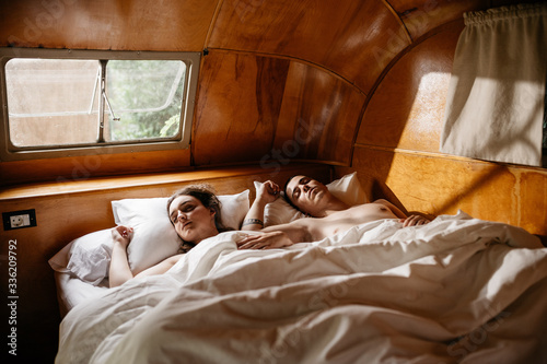 Young cute couple sleeping together at bed photo