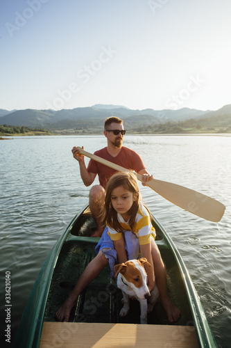 Dad and son canoeing at the lake photo