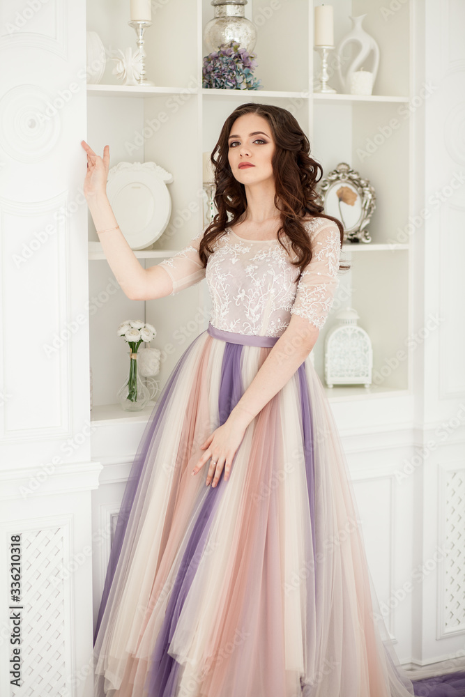 Bride in color wedding dress. Beautiful model in a beautiful wedding dress in a white photo studio. Portrait of an attractive girl in a beautiful interior. Bride in color wedding dress. Beautiful model in a beautiful wedding dress in a white photo studio. Portrait of an attractive girl in a beautiful interior.