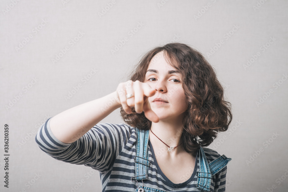 A woman shows a finger forward A woman shows a finger forward