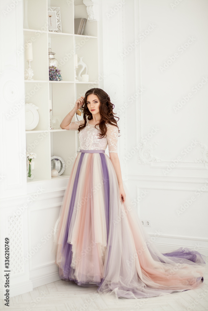 Bride in color wedding dress. Beautiful model in a beautiful wedding dress in a white photo studio. Portrait of an attractive girl in a beautiful interior. Bride in color wedding dress. Beautiful model in a beautiful wedding dress in a white photo studio. Portrait of an attractive girl in a beautiful interior.