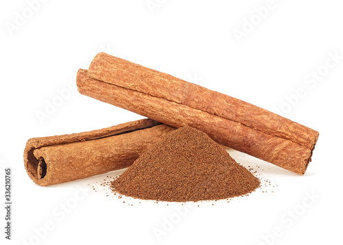 Two cinnamon sticks and powder isolated on a white background