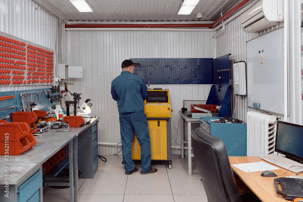 Man Using Rail Injector Test Bench Man Using Rail Injector Test Bench