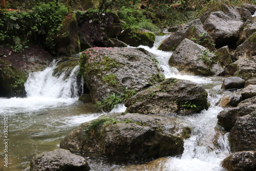 Beautiful landscape of cascade falls over mossy rocks  stones cover with moss  in a Mountain in Sichuan  China