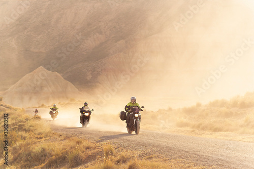 People Riding Motorcycle in the desert photo