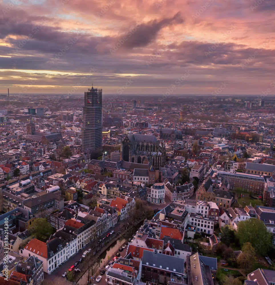Aerial of Utrecht historic city center with the Dom church during impressive sunset with fire colour clouds