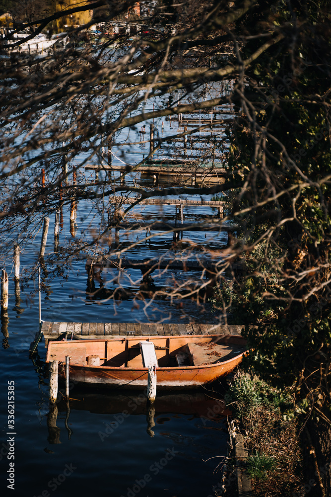 lonely moored rowboat on shore of a lake