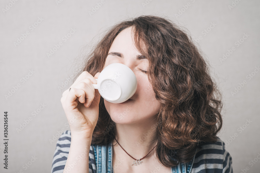 girl drinking coffee, dressed in overalls girl drinking coffee, dressed in overalls