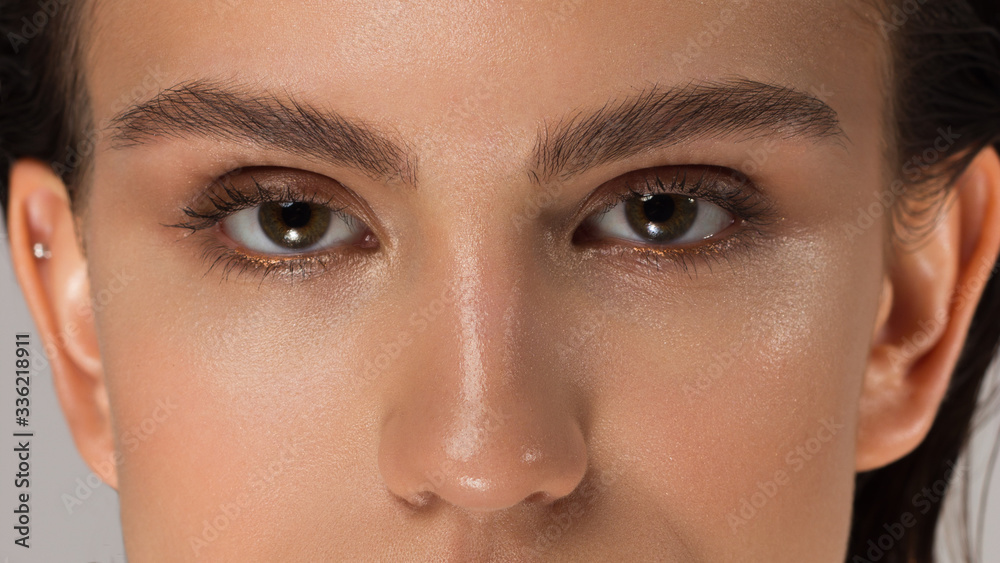 Elegance close-up female eye with dark brown eyeshadow. Macro shot of part of the face of a beautiful woman. Wellness, cosmetics and makeup. smooth beautiful eyebrows and eyelashes Elegance close-up female eye with dark brown eyeshadow. Macro shot of part of the face of a beautiful woman. Wellness, cosmetics and makeup. smooth beautiful eyebrows and eyelashes