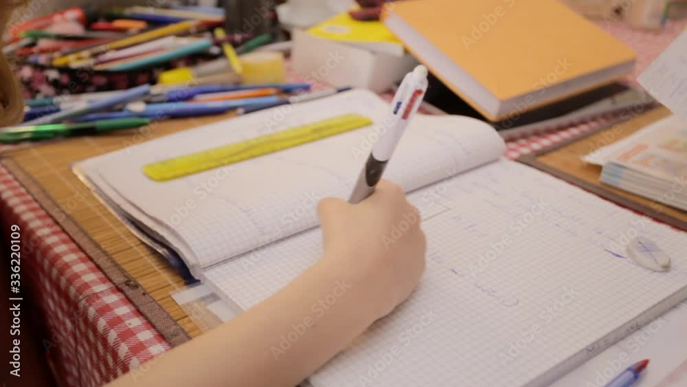 A little girl doing her homework (schoolwork that a pupil is required to do at home). Detail shot of her hand writing results of a math problem on a workbook.
A little girl doing her homework (schoolwork that a pupil is required to do at home). Detail shot of her hand writing results of a math problem on a workbook.