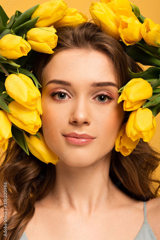 beautiful smiling girl in fresh tulip flowers isolated on yellow beautiful smiling girl in fresh tulip flowers isolated on yellow
