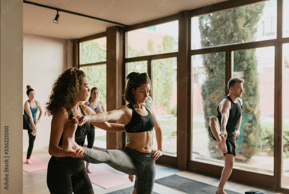 Scene of a group of people practicing yoga in class. Scene of a group of people practicing yoga in class.