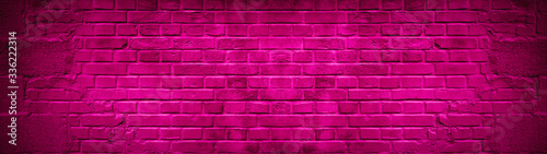 Pink colorful abstract damaged rustic brick wall texture banner panorama © Corri Seizinger