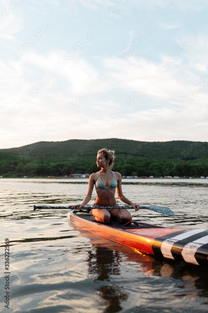 Beautiful slim woman on paddle board Beautiful slim woman on paddle board