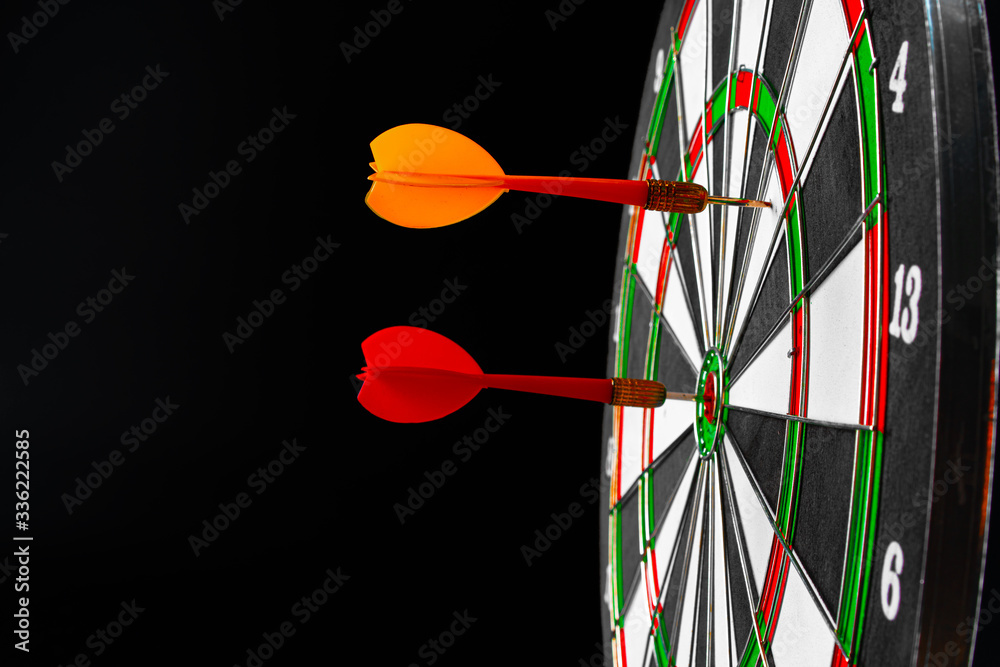 Dartboard on black dark background close up. Aiming concept Dartboard on black dark background close up. Aiming concept