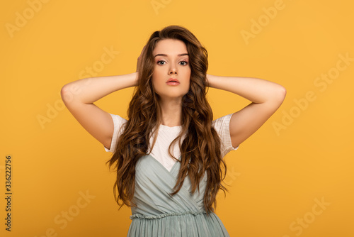 attractive spring woman with long hair isolated on yellow