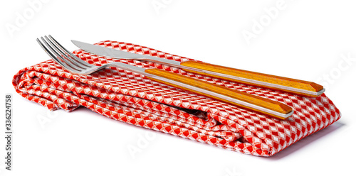 Set of fork and knife on towel. Isolated on white background. Top view.
