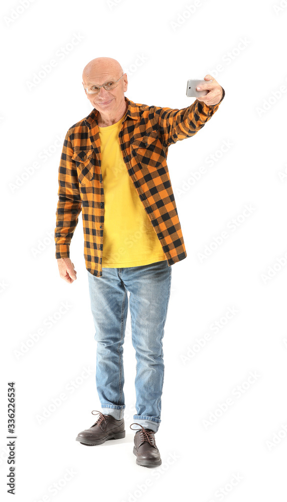 Portrait of elderly man taking selfie on white background Portrait of elderly man taking selfie on white background