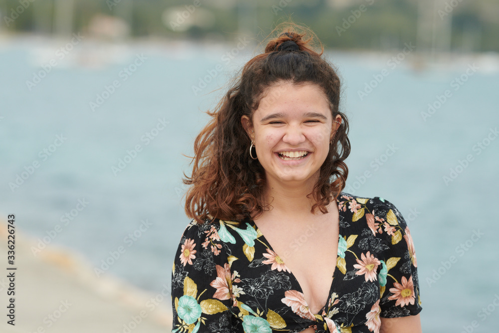 Charming woman laughing at camera on beach Charming woman laughing at camera on beach