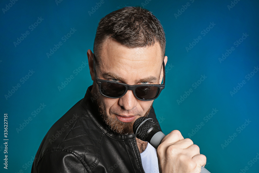 Male singer with microphone on dark background Male singer with microphone on dark background