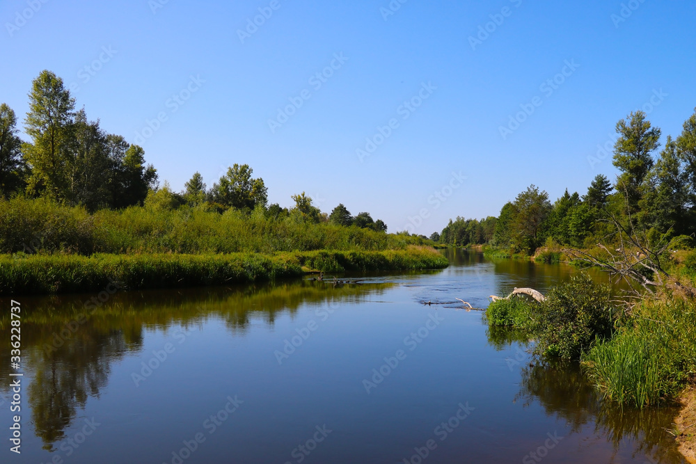 A winding shallow river on a clear summer day. A winding shallow river on a clear summer day.