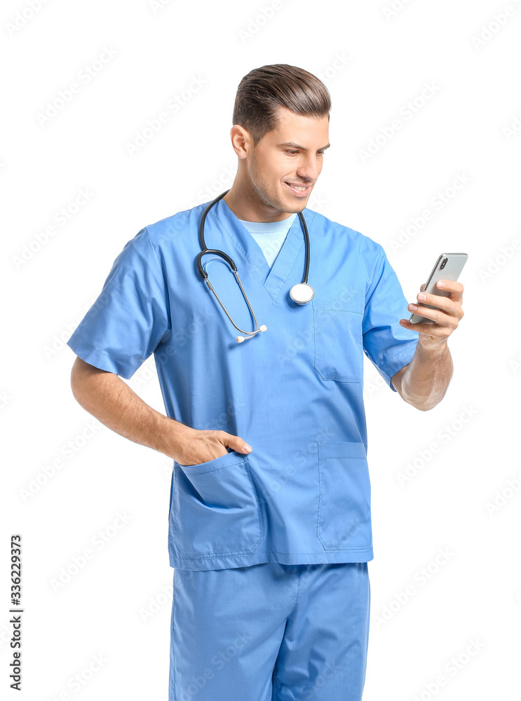 Portrait of young male doctor with mobile phone on white background Portrait of young male doctor with mobile phone on white background